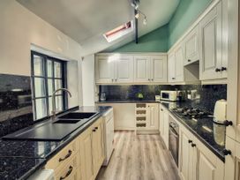 A kitchen with a sink, cabinets, and appliances at 20 Bridge Street Morpeth