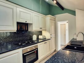 A kitchen with cabinets and appliances at 20 Bridge Street in Morpeth