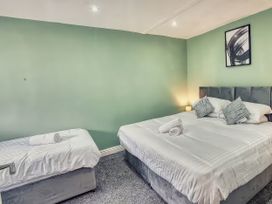 A bedroom with two beds and a piece of wall art at 20 Bridge Street in Morpeth