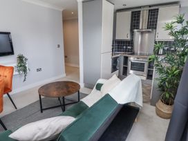 A living room with a sofa and coffee table at 16 The Viking in Seahouses