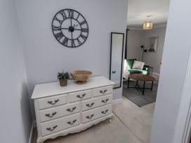 A hallway with a dresser and mirror at 16 The Viking in Seahouses