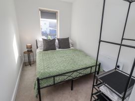 A bedroom with a bed and bedside table at 16 The Viking in Seahouses