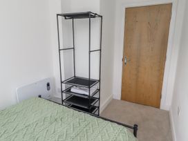 A bedroom with a bed and shelf in 16 The Viking Seahouses