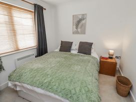 A bedroom with a bed and nightstand at 16 The Viking in Seahouses