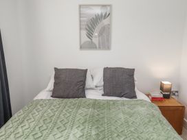 A bedroom with a bed and nightstand at 16 The Viking in Seahouses