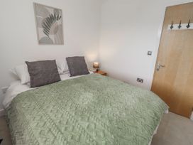 A bedroom with a bed and bedside table at 16 The Viking in Seahouses