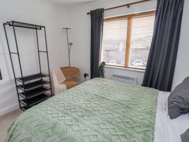 A bedroom with a bed and shelf at 16 The Viking in Seahouses