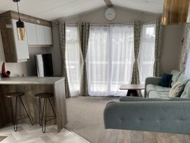 A living room with a sofa and television at WW15 Plot in Newquay