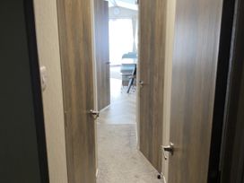 A hallway with doors and carpet at WW15 Plot in Newquay