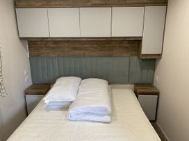 A bedroom with a bed and wall cabinets at WW15 Plot in Newquay