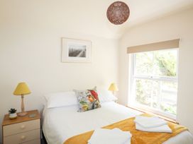 A bedroom with a bed and bedside table at Llys Elen in Caernarfon