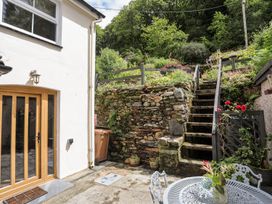 An outdoor area with steps leading up and a table and chairs at Llys Elen Caernarfon