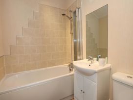 A bathroom with a bathtub, sink, and toilet at Tiggywinkle Beck - White Cross Bay in Windermere