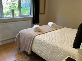 A bedroom with a bed and towels on top at Owls House - White Cross Bay Windermere