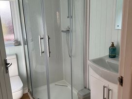 A bathroom with a shower and sink at Owls House - White Cross Bay Windermere