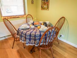 A dining room with a table set for breakfast at 17 Demesne Gardens, Ipswich