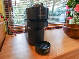 A coffee machine with a drip tray and a wooden bowl at 17 Demesne Gardens, Ipswich