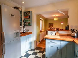 A kitchen with cabinets and appliances at 17 Demesne Gardens in Ipswich