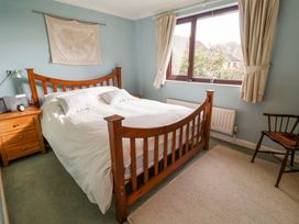 A bedroom with a bed and bedside table at 17 Demesne Gardens in Ipswich