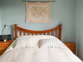 A bedroom with a bed and nightstand at 17 Demesne Gardens in Ipswich