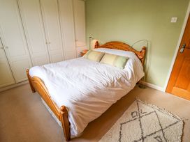 A bedroom with a bed and wardrobe at 17 Demesne Gardens Ipswich