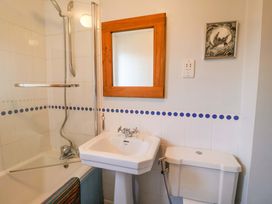 A bathroom with a shower, bathtub, sink, and toilet at 17 Demesne Gardens, Ipswich
