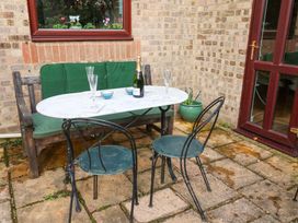 A table with chairs and champagne on a patio at 17 Demesne Gardens in Ipswich