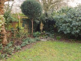 A garden with a statue and shrubs at 17 Demesne Gardens, Ipswich