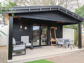 An outdoor area with seating and a table at Caban Tan Y Dderwen in Chwilog