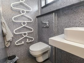 A bathroom with a toilet and sink at Caban Tan Y Ffawydd Chwilog near Y Ffor