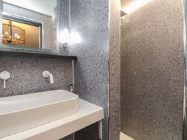 A bathroom with a sink and shower at Caban Tan Y Ffawydd in Chwilog near Y Ffor