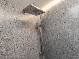 A shower with a shower head and hose at Caban Tan Y Ffawydd in Chwilog near Y Ffor