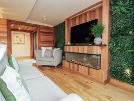 A living room with a sofa and armchair at Riverside Lodge in Afonwen