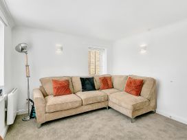 A living room with a sofa and throw pillows at 40 Raleigh Court in Sherborne