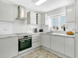 A kitchen with an oven and sink at 40 Raleigh Court in Sherborne