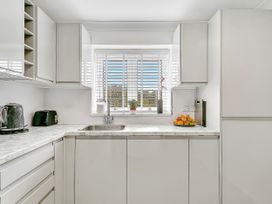 A kitchen with a sink and kettle at 40 Raleigh Court in Sherborne
