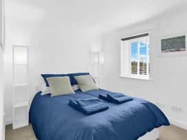 A bedroom with a bed and shelves at 40 Raleigh Court Sherborne