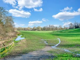 A field with grass and trees at 40 Raleigh Court in Sherborne