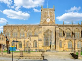 A church building with a clock tower and stained glass windows at 40 Raleigh Court, Sherborne