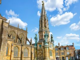 A monument with statues and spire near a building at 40 Raleigh Court, Sherborne