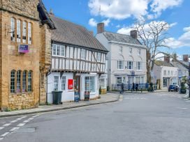 A street view with various buildings and pedestrians at 40 Raleigh Court, Sherborne