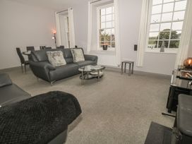 A living room with a sofa and coffee table at The Sea Chest in Alnmouth