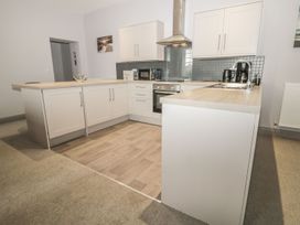 A kitchen with cabinets and appliances at The Sea Chest in Alnmouth