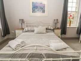 A bedroom with a bed and bedside tables at The Sea Chest in Alnmouth