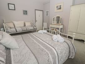 A bedroom with a bed and a couch at The Sea Chest in Alnmouth