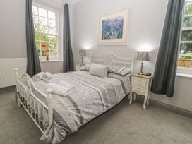 A bedroom with a bed and bedside table at The Sea Chest in Alnmouth