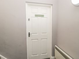 A door with a nameplate in a hallway at The Sea Chest in Alnmouth