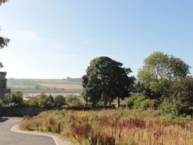 A view of a landscape with trees and grass at The Sea Chest in Alnmouth