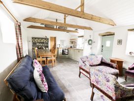 A living room with a dining table and chairs at Rhos Y Clegryn in Goodwick