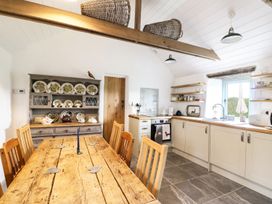 A kitchen with a dining table and chairs at Rhos Y Clegryn in Goodwick